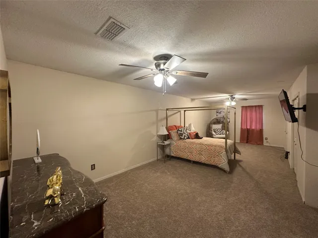 a living room with furniture and a ceiling fan