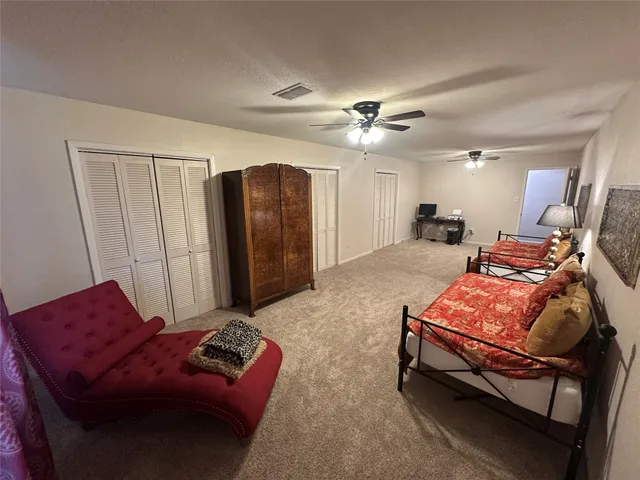 a bathroom with a granite countertop sink toilet and mirror
