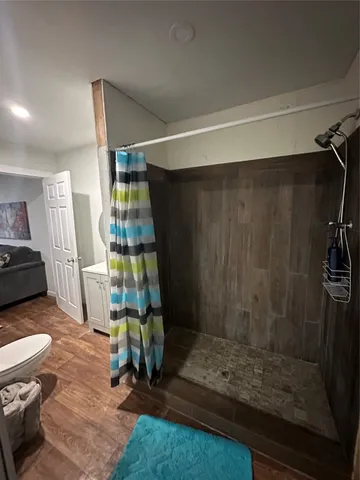 a bathroom with a sink toilet and shower