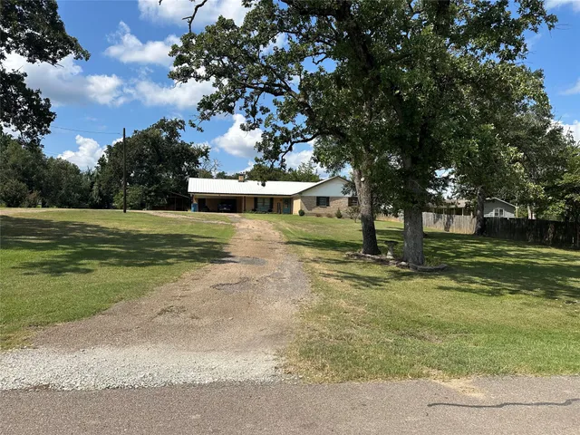 a view of a park with large trees