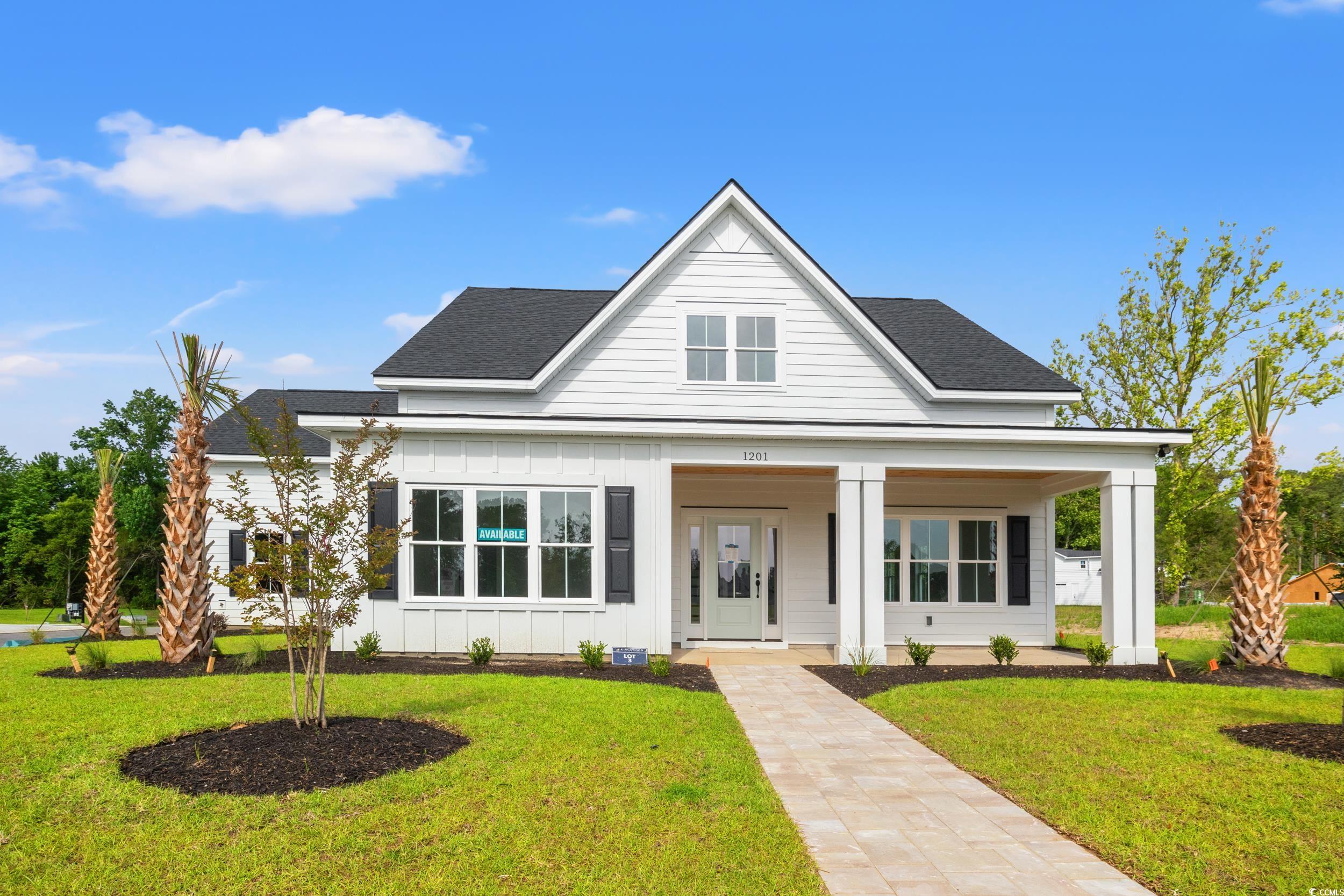 1201 Possum Trot Road North Myrtle Beach, SC 29582 - Photo 1 of 33 View of front facade with board and batten siding, a front yard, and a porch