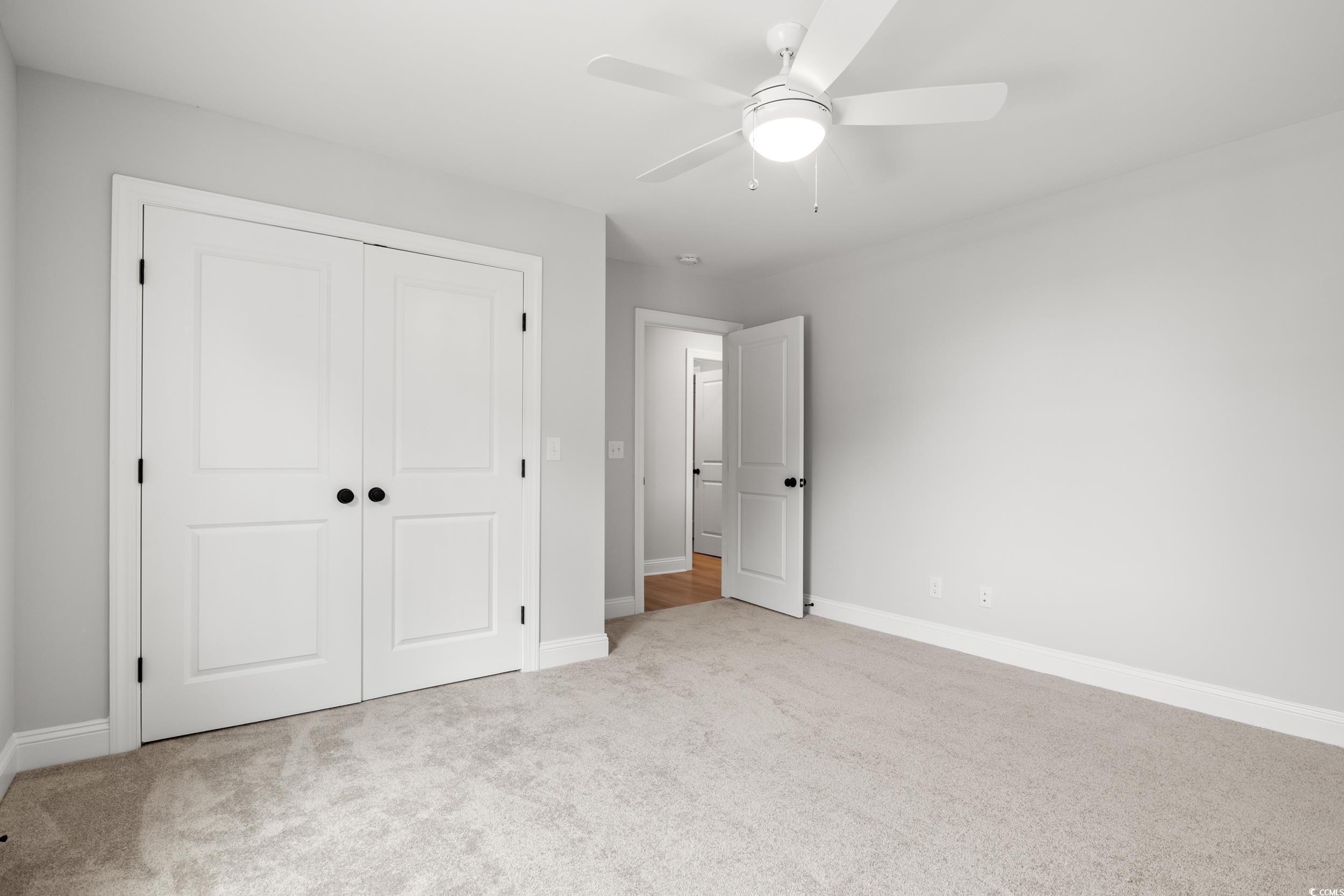 1201 Possum Trot Road North Myrtle Beach, SC 29582 - Photo 19 of 33 Spare room featuring ornamental molding, light wood-type flooring, baseboards, and ceiling fan