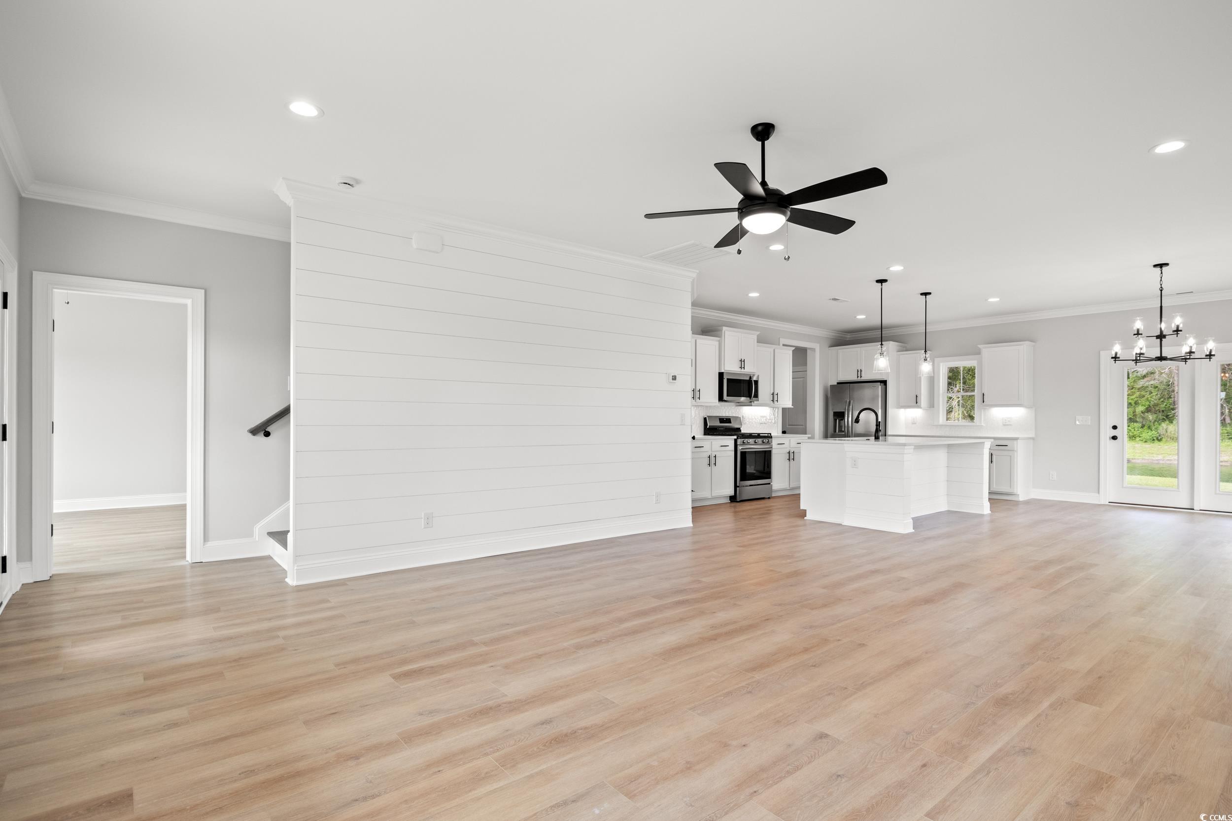 1201 Possum Trot Road North Myrtle Beach, SC 29582 - Photo 3 of 33 Unfurnished living room featuring crown molding, ceiling fan, a chandelier, recessed lighting, and baseboards