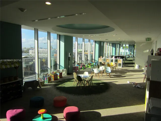 a living room with fireplace furniture and a large window