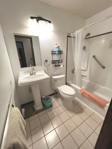 a bathroom with a sink toilet and shower