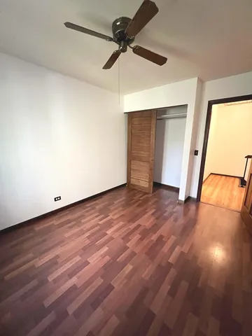a view of an empty room and wooden floor
