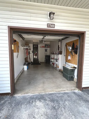 a view of a water heater and a refrigerator in a room
