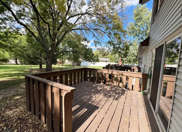 a view of balcony with wooden floor and fence