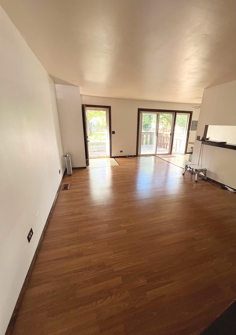 7749 West Harbor Court Frankfort, IL 60423 - Photo 7 of 17 wooden floor in an empty room with a window