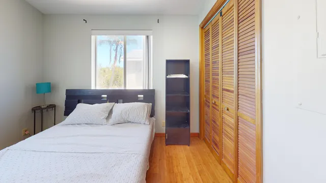 a bedroom with a bed and window