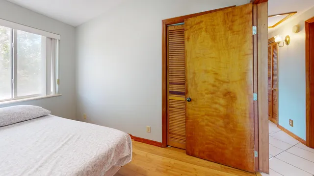 a bathroom with a granite countertop sink mirror vanity and toilet