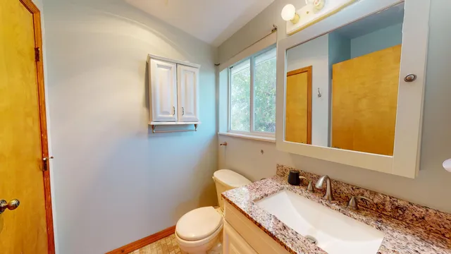 a front view of a house with a tree