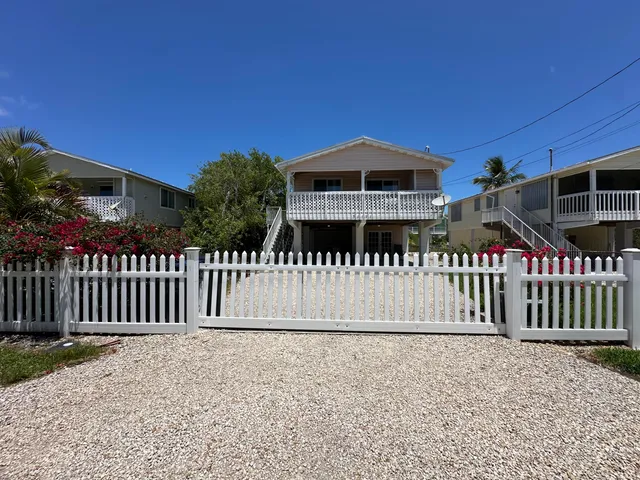 an aerial view of a house with a yard and sitting area