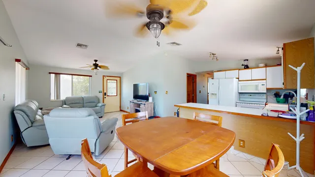 a view of a dining room with furniture and a chandelier
