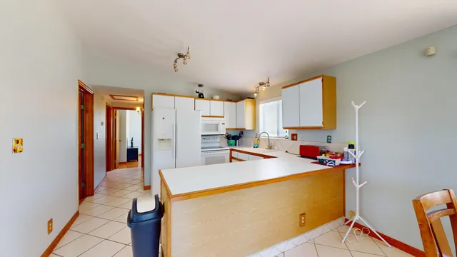 a kitchen that has a sink and a refrigerator