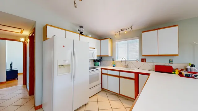 a kitchen with stainless steel appliances a refrigerator sink and cabinets