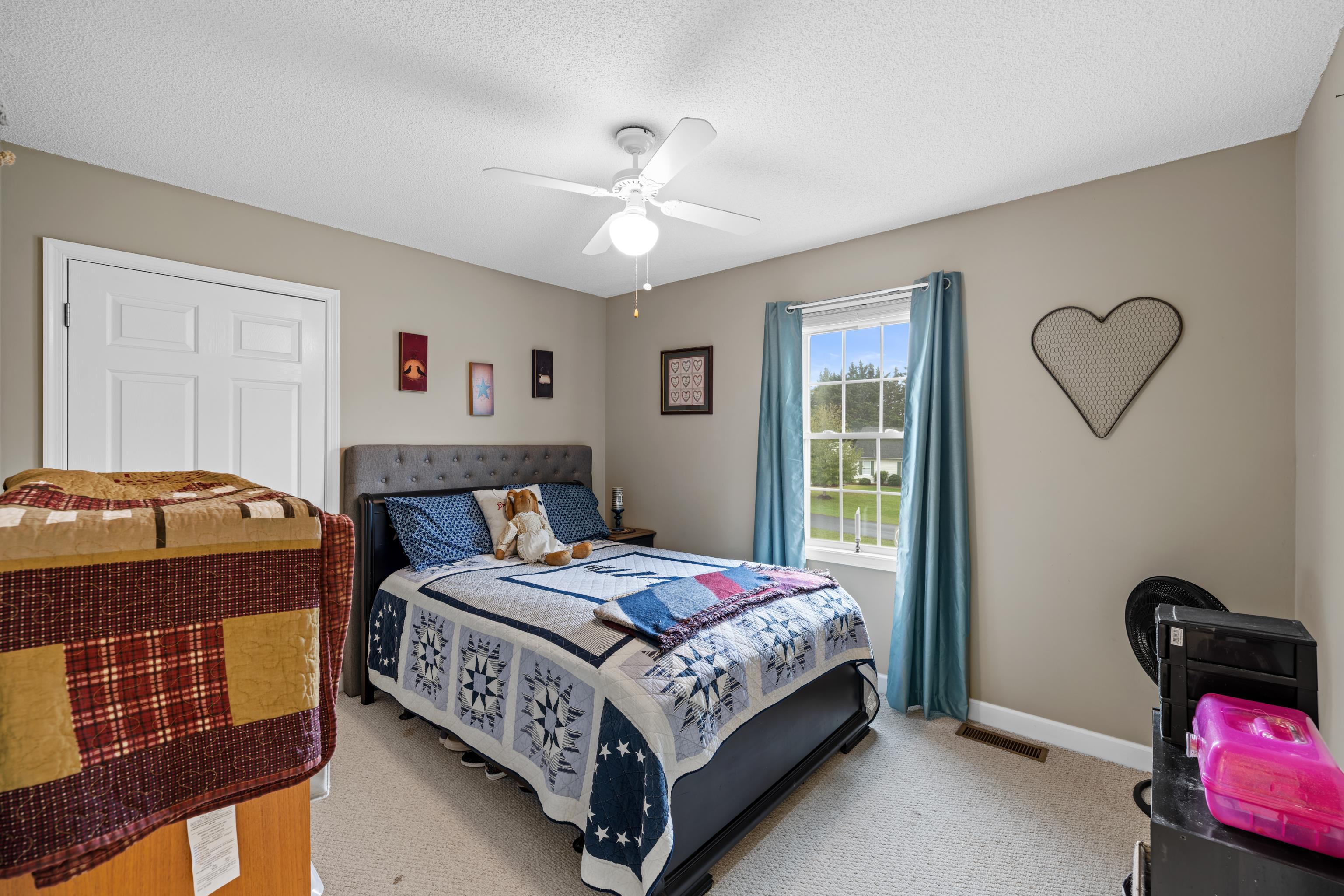 48 Meadow Ridge Road Waynesboro, VA 22980 - Photo 39 of 71 a bedroom with a bed and a chandelier
