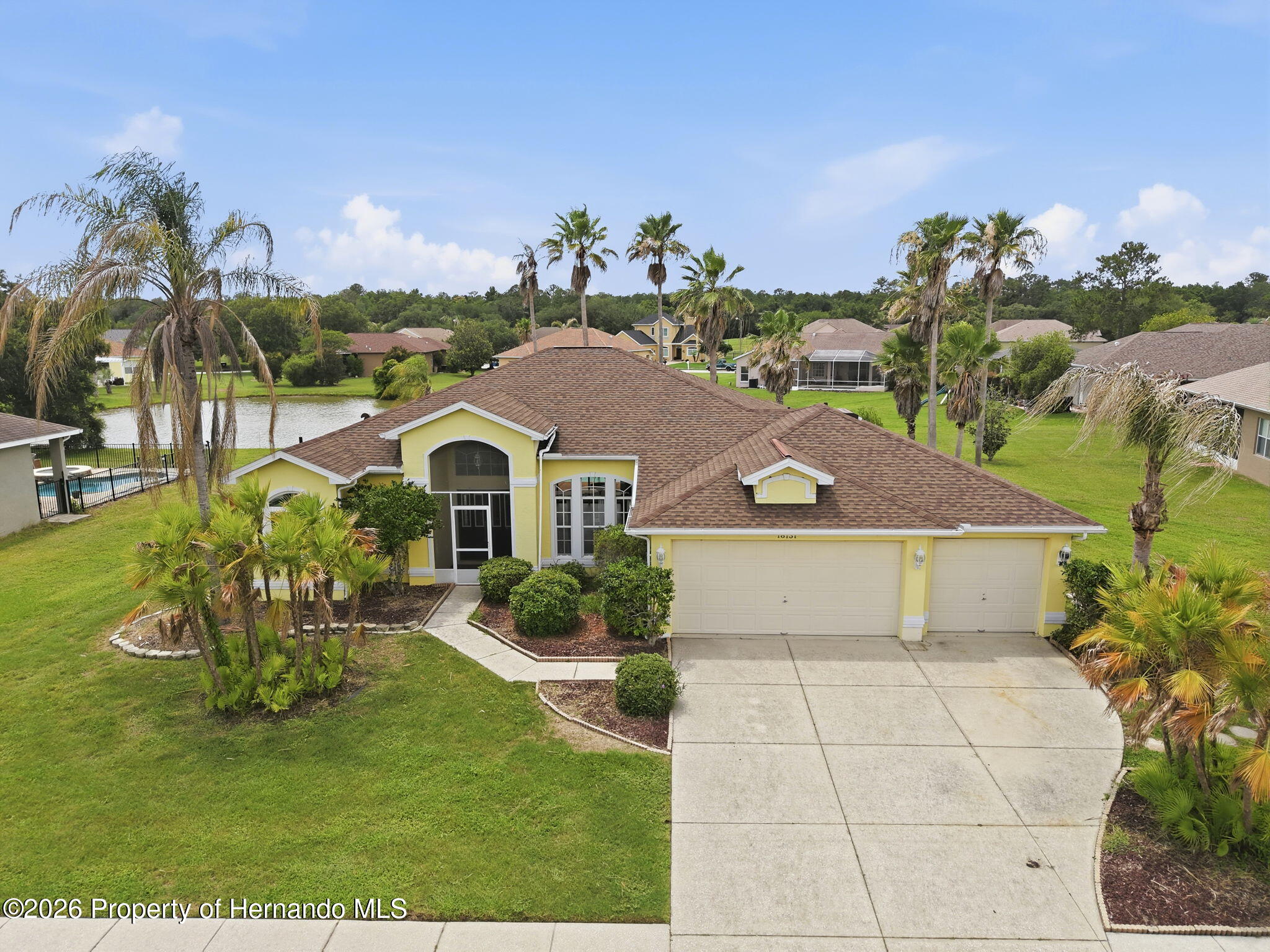 18131 Rivard Boulevard Brooksville, FL 34604 - Photo 52 of 66 a front view of a house with a garden