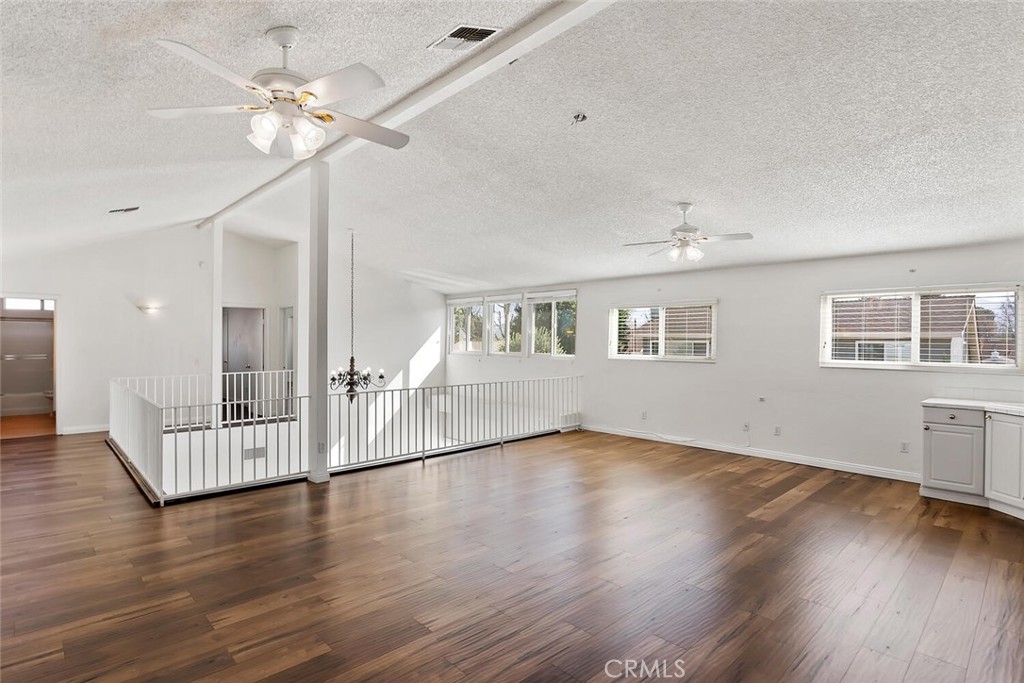 23850 Vía Jacara Valencia, CA 91355 - Photo 18 of 41 a view of an empty room with wooden floor and a ceiling fan