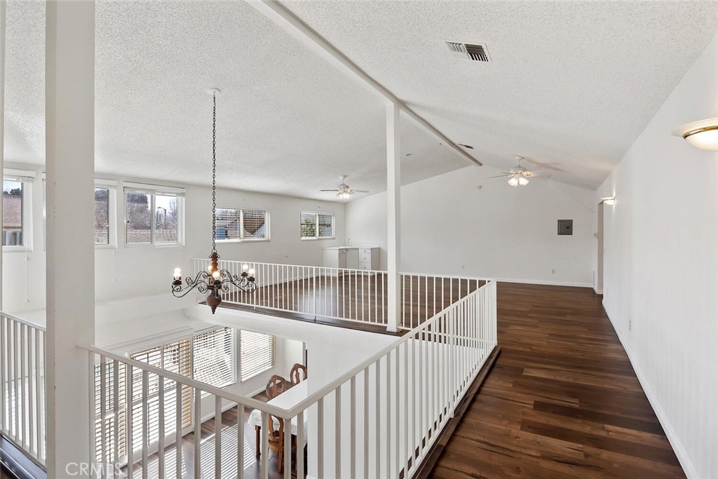 23850 Vía Jacara Valencia, CA 91355 - Photo 19 of 41 a view of a hallway with wooden floor