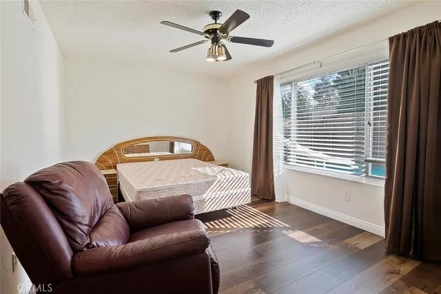 a bedroom with furniture and wooden floor