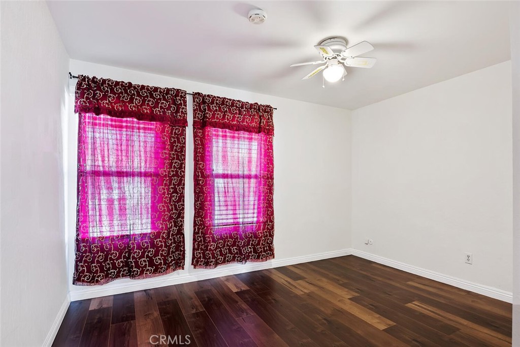 23850 Vía Jacara Valencia, CA 91355 - Photo 25 of 41 a view of an empty room with wooden floor and fan