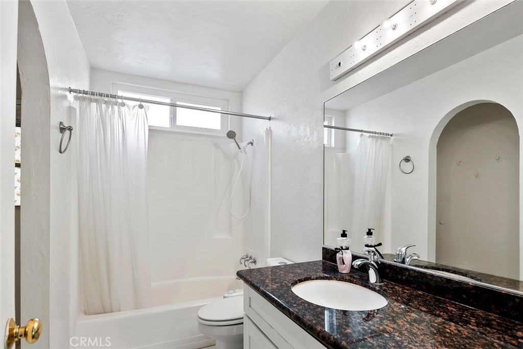 23850 Vía Jacara Valencia, CA 91355 - Photo 26 of 41 a bathroom with a sink toilet a mirror and shower