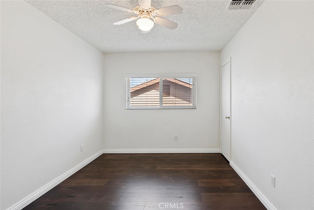 23850 Vía Jacara Valencia, CA 91355 - Photo 28 of 41 an empty room with wooden floor and windows