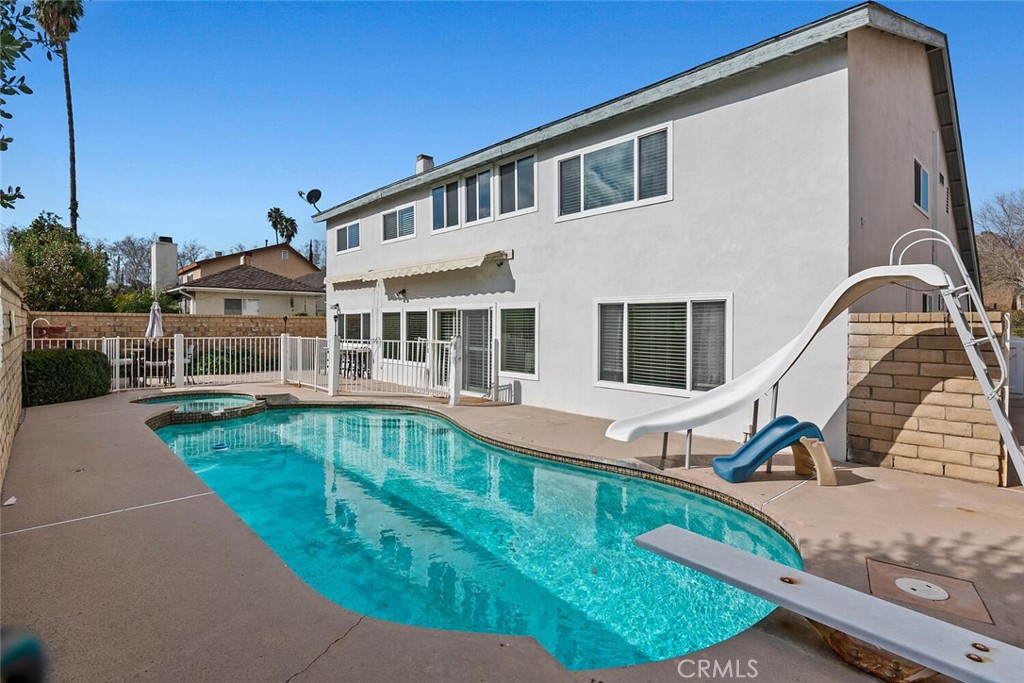 23850 Vía Jacara Valencia, CA 91355 - Photo 32 of 41 a front view of a house with swimming pool