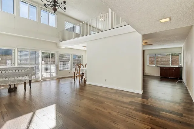 a view of empty room with wooden floor and floor to ceiling window