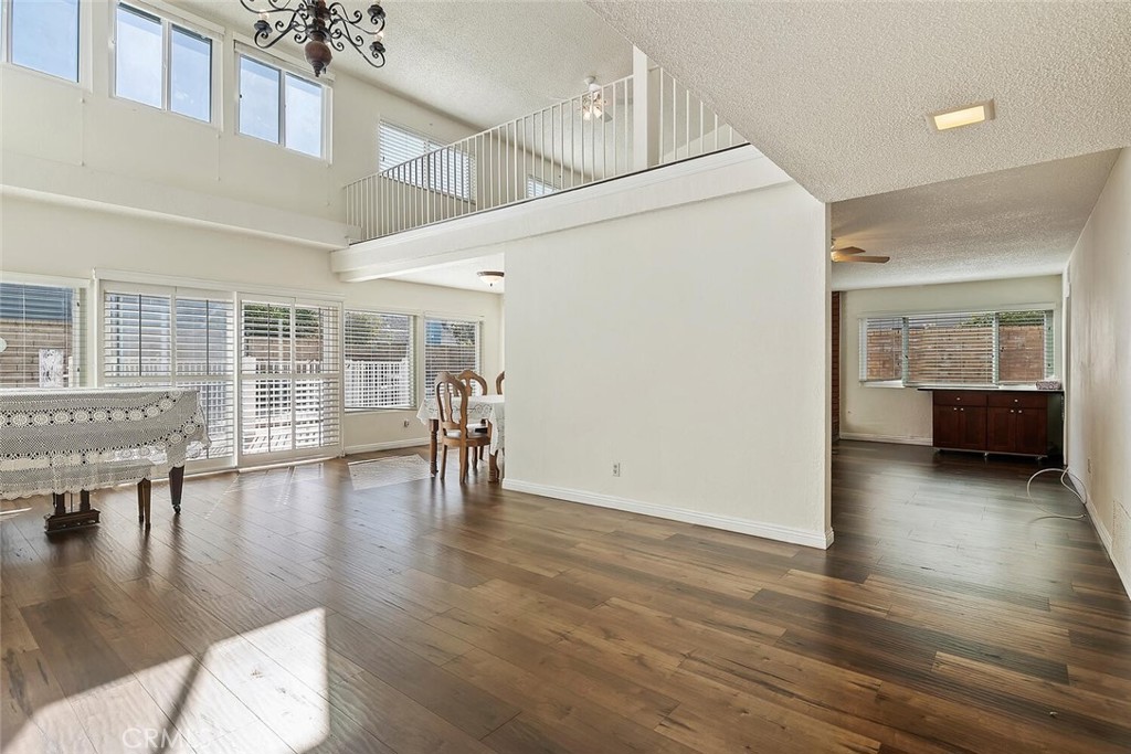 23850 Vía Jacara Valencia, CA 91355 - Photo 7 of 41 a view of empty room with wooden floor and floor to ceiling window