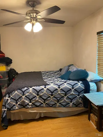 a bed sitting in a bedroom next to a window