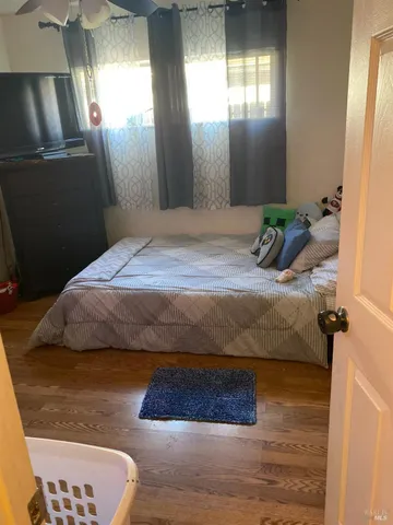 a bedroom with a bed and a mirror
