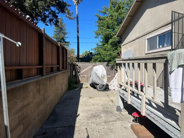 a view of balcony with wooden floor and seating space