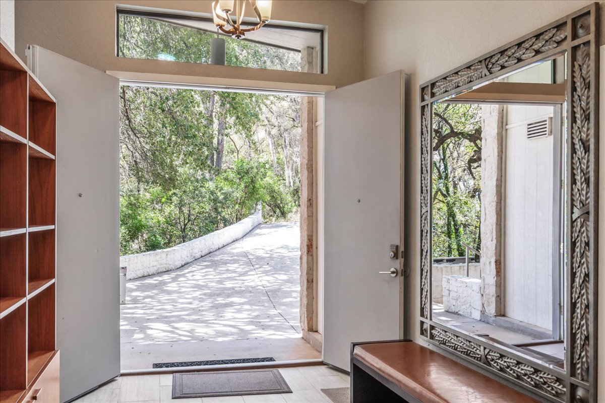 207 Rogers Ridge Street San Marcos, TX 78666 - Photo 3 of 35 A bright, open entry welcomes you with warm wood flooring, graceful transom windows, & an inviting tone throughout the home.