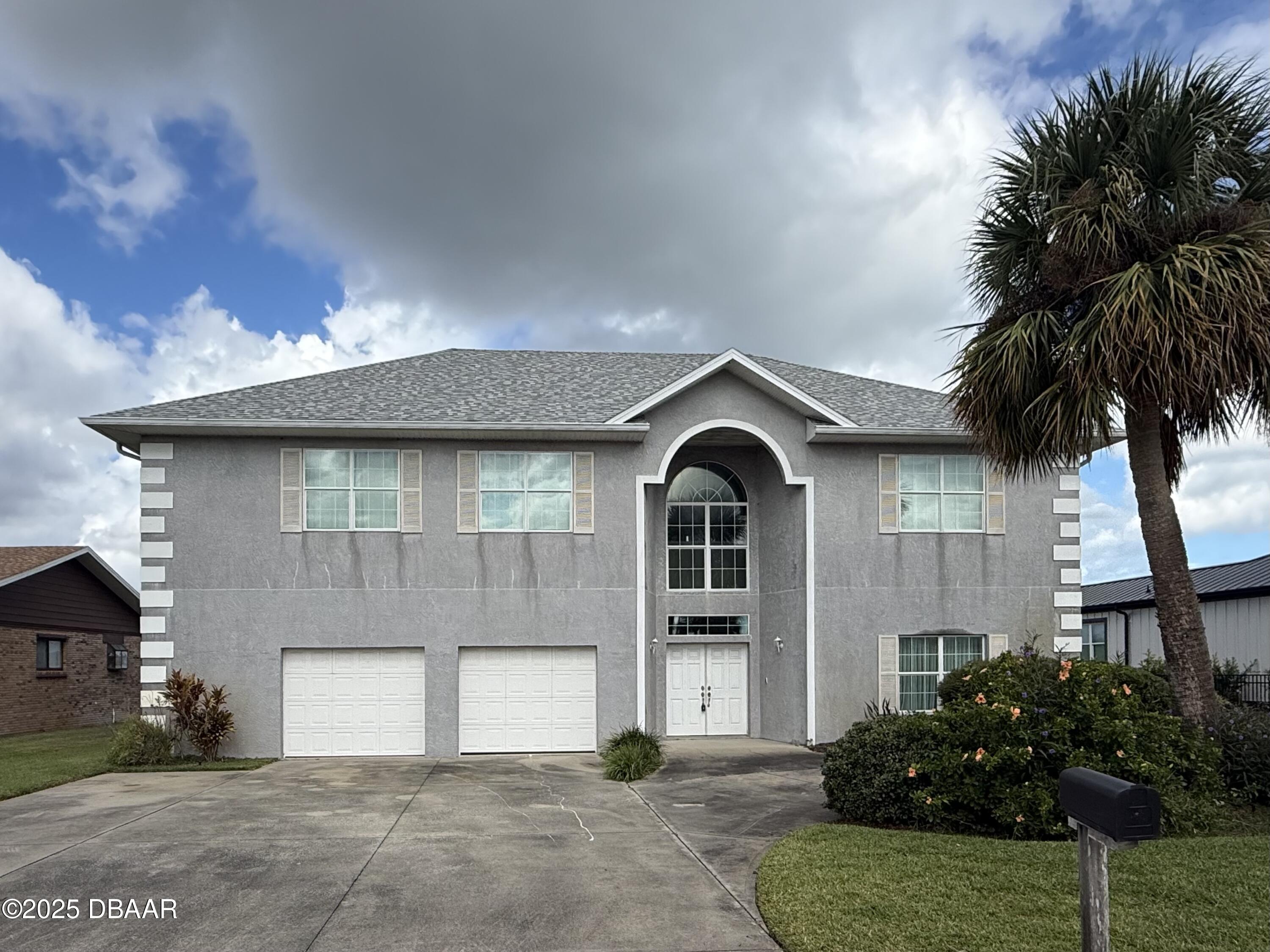 126 Carriage Ponce Inlet, FL 32127 - Photo 15 of 20 a front view of a house with a garden