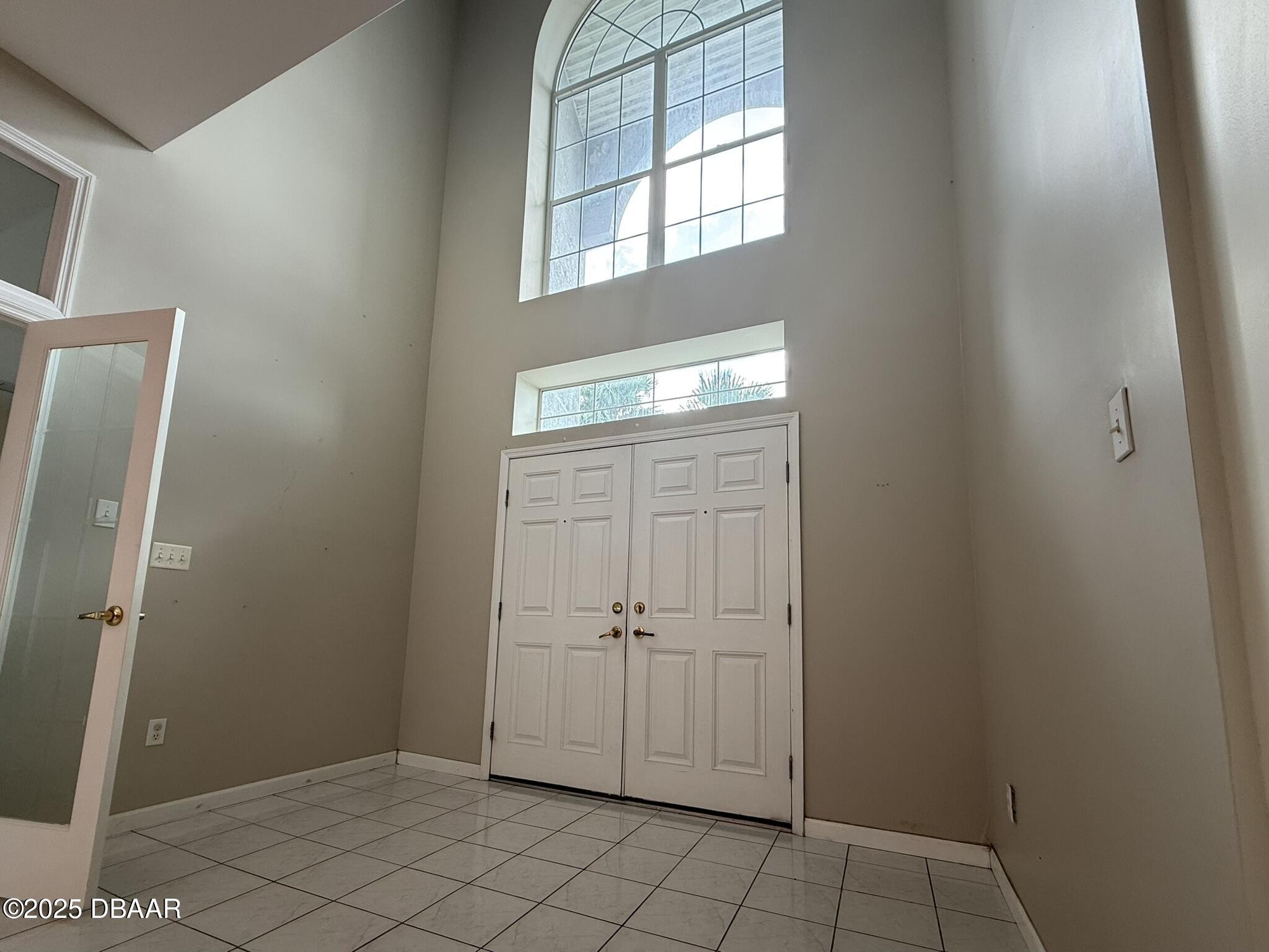 126 Carriage Ponce Inlet, FL 32127 - Photo 3 of 20 a view of an empty room with windows
