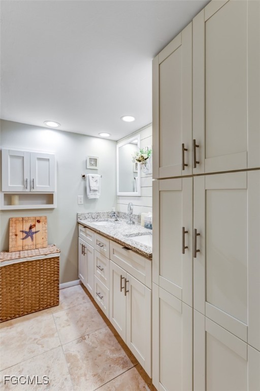 5710 Trailwinds Drive, Unit 525 Fort Myers, FL 33907 - Photo 15 of 37 a spacious bathroom with a double vanity sink a mirror and a bathtub