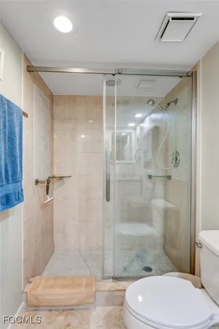 a bathroom with a shower a toilet and sink