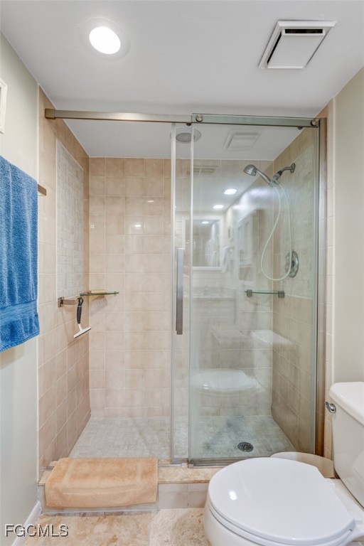 5710 Trailwinds Drive, Unit 525 Fort Myers, FL 33907 - Photo 16 of 37 a bathroom with a shower a toilet and sink