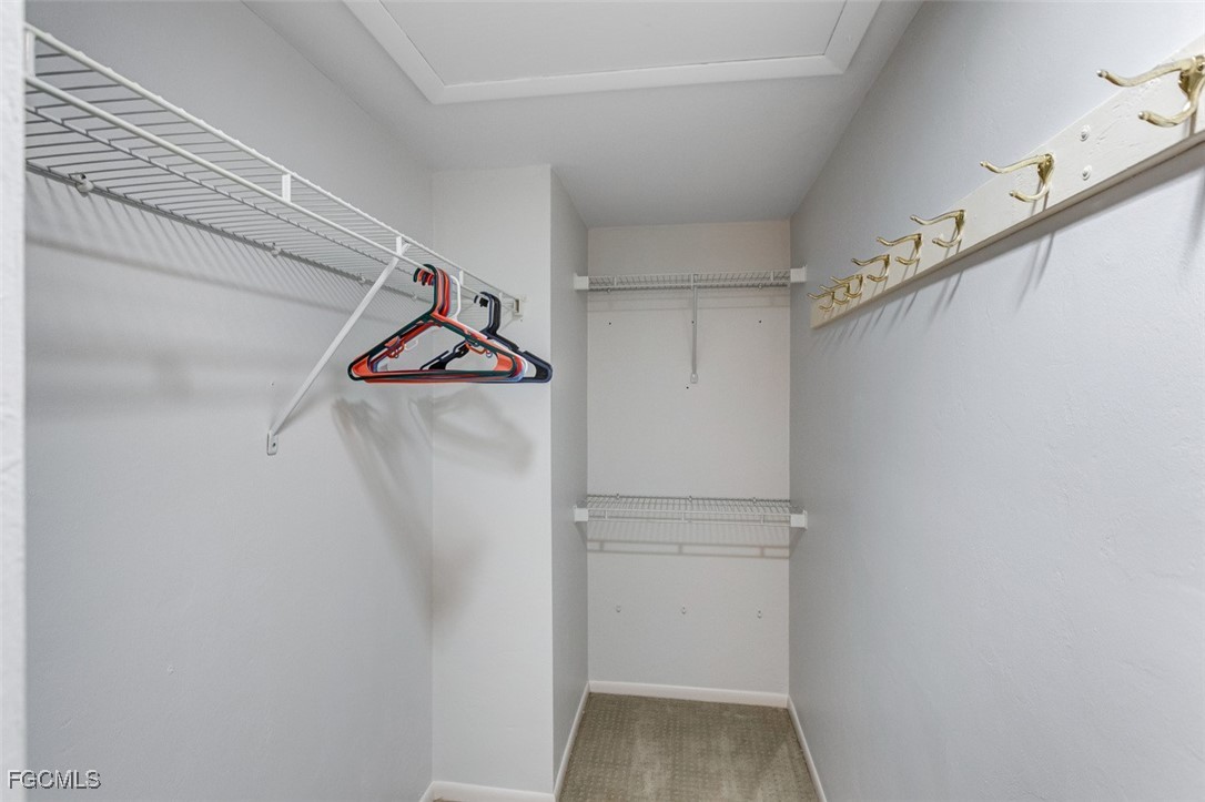 5710 Trailwinds Drive, Unit 525 Fort Myers, FL 33907 - Photo 18 of 37 a view of walk in closet with clothes and shoes
