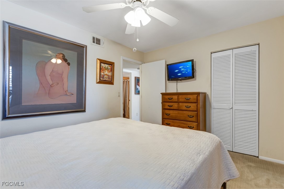 5710 Trailwinds Drive, Unit 525 Fort Myers, FL 33907 - Photo 19 of 37 a bedroom with a bed dresser and a window