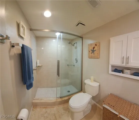 a bathroom with a toilet sink and shower