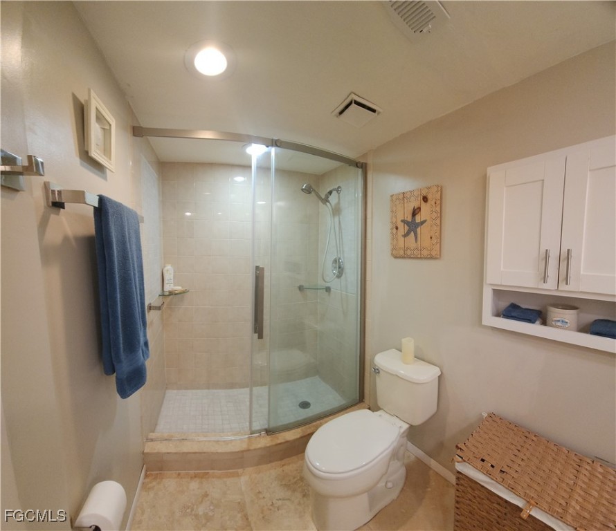 5710 Trailwinds Drive, Unit 525 Fort Myers, FL 33907 - Photo 21 of 37 a bathroom with a toilet sink and shower