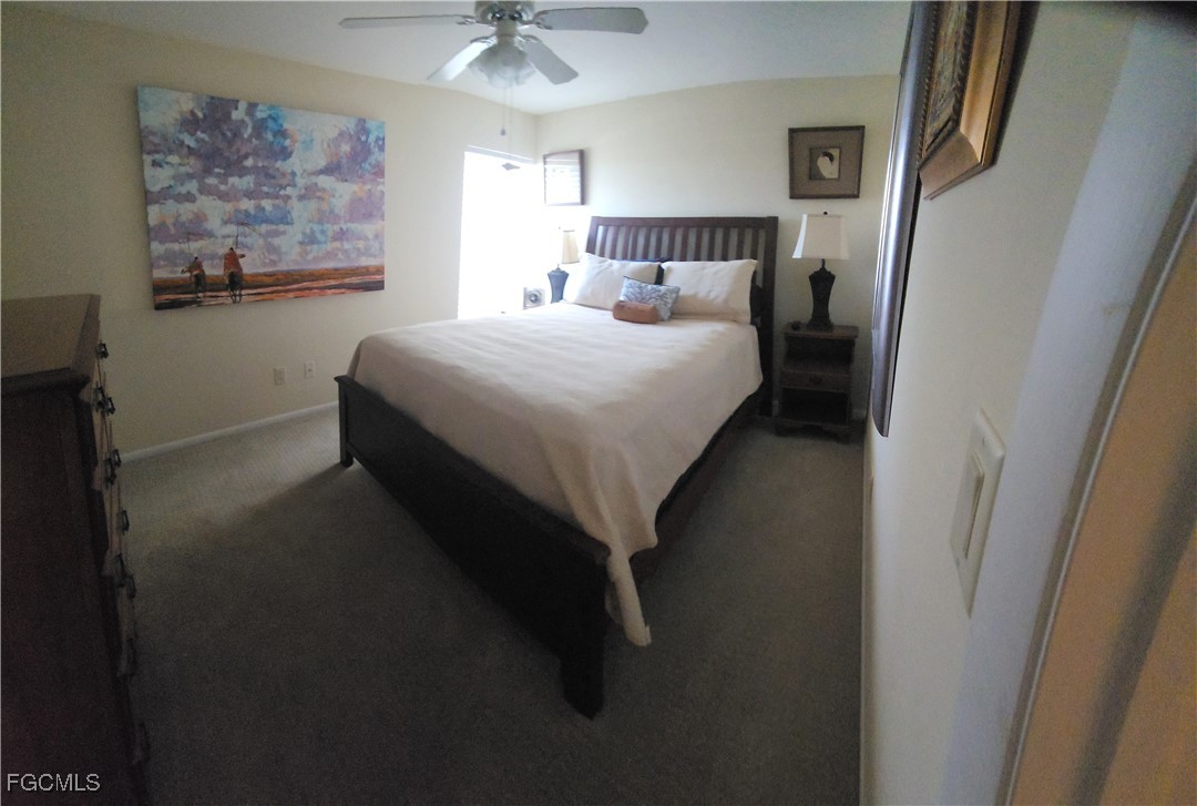 5710 Trailwinds Drive, Unit 525 Fort Myers, FL 33907 - Photo 23 of 37 a bedroom with a bed and painting on the wall