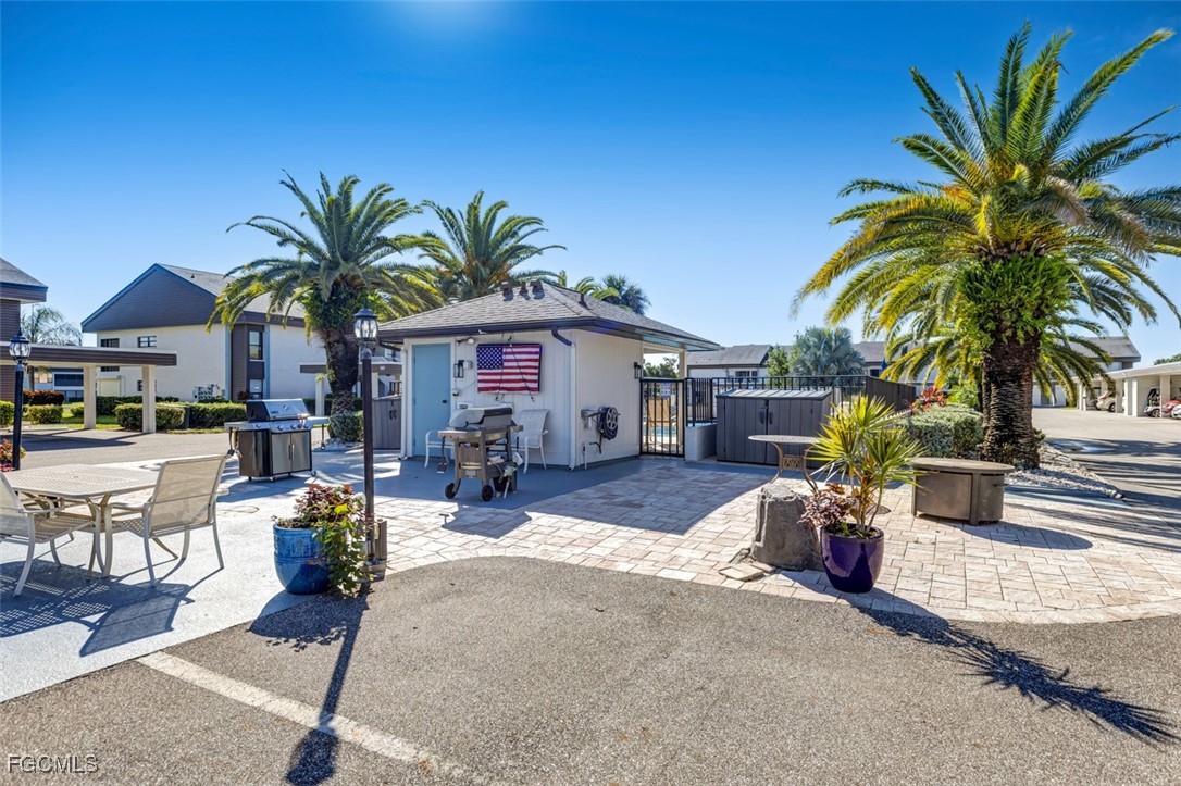 5710 Trailwinds Drive, Unit 525 Fort Myers, FL 33907 - Photo 26 of 37 a view of a patio with swimming pool table and chairs