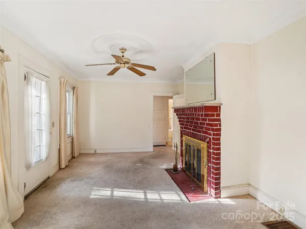 a living room with a fireplace furniture and a window