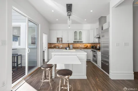 a kitchen with a stove a sink and a refrigerator