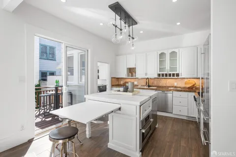 a living room with furniture and a kitchen