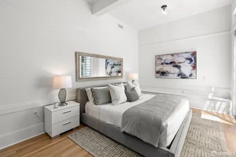 a bedroom with bed and a potted plant